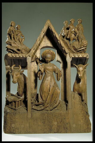 Sage-femme dans l'étable de la Nativité surmontée des figures des bergers et des mages