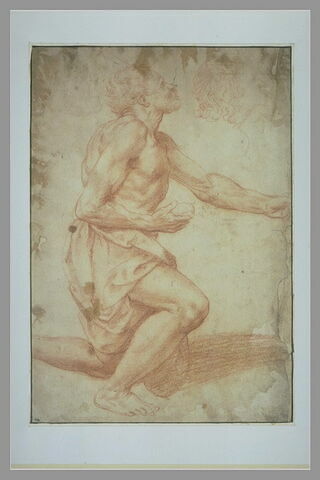 Homme à demi nu, à genoux, une pierre à la main ; esquisse d'un profil