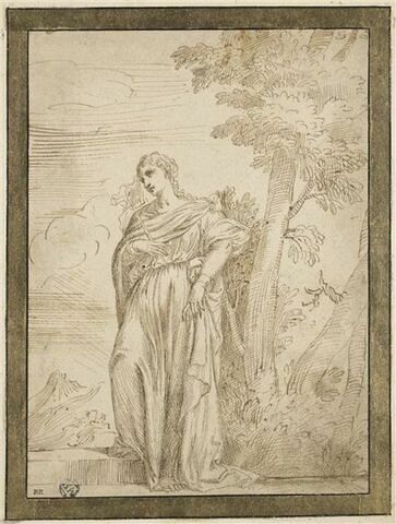 Une femme, debout au pied d'un arbre, tenant une croix dans la main droite, image 1/2