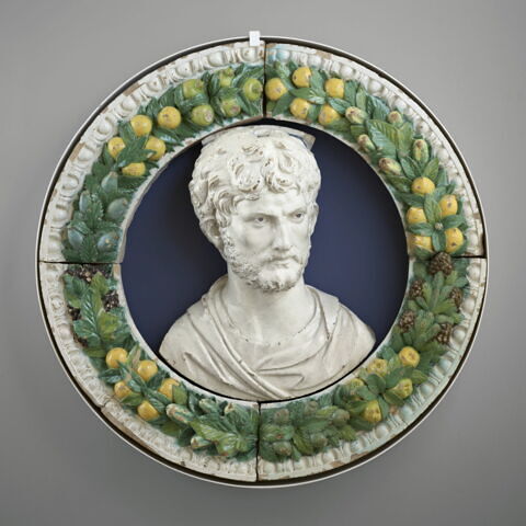 Buste d'homme barbu, encadrement de fruits et de feuillages