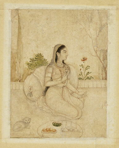 Jeune femme agenouillée tenant un flacon et une coupe