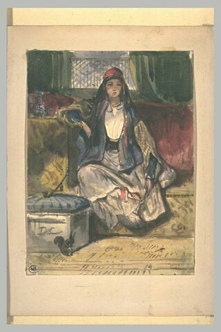 Jeune orientale assise sur un divan, dans un intérieur, fumant, image 1/1