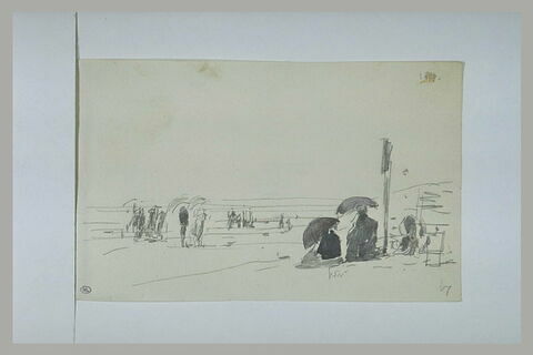 Deux femmes, assises, près d'un poteau, sur une plage, image 1/1
